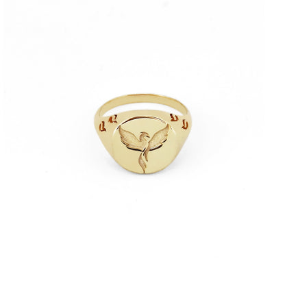 solid yellow gold polished round signet ring engraved with a phoenix firebird rising with flame cutouts around the base of the ring's head