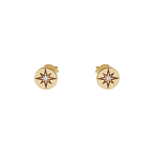 pair of solid yellow gold north star disc stud earrings set with a tiny diamond in the center