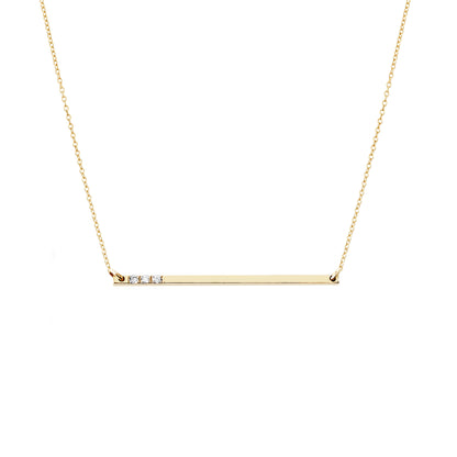solid yellow gold thin bar necklace set with three tiny white diamonds