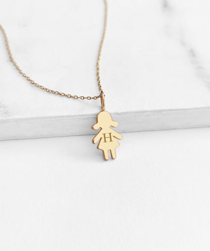 yellow gold necklace with tiny girl outline charm engraved with a monogram