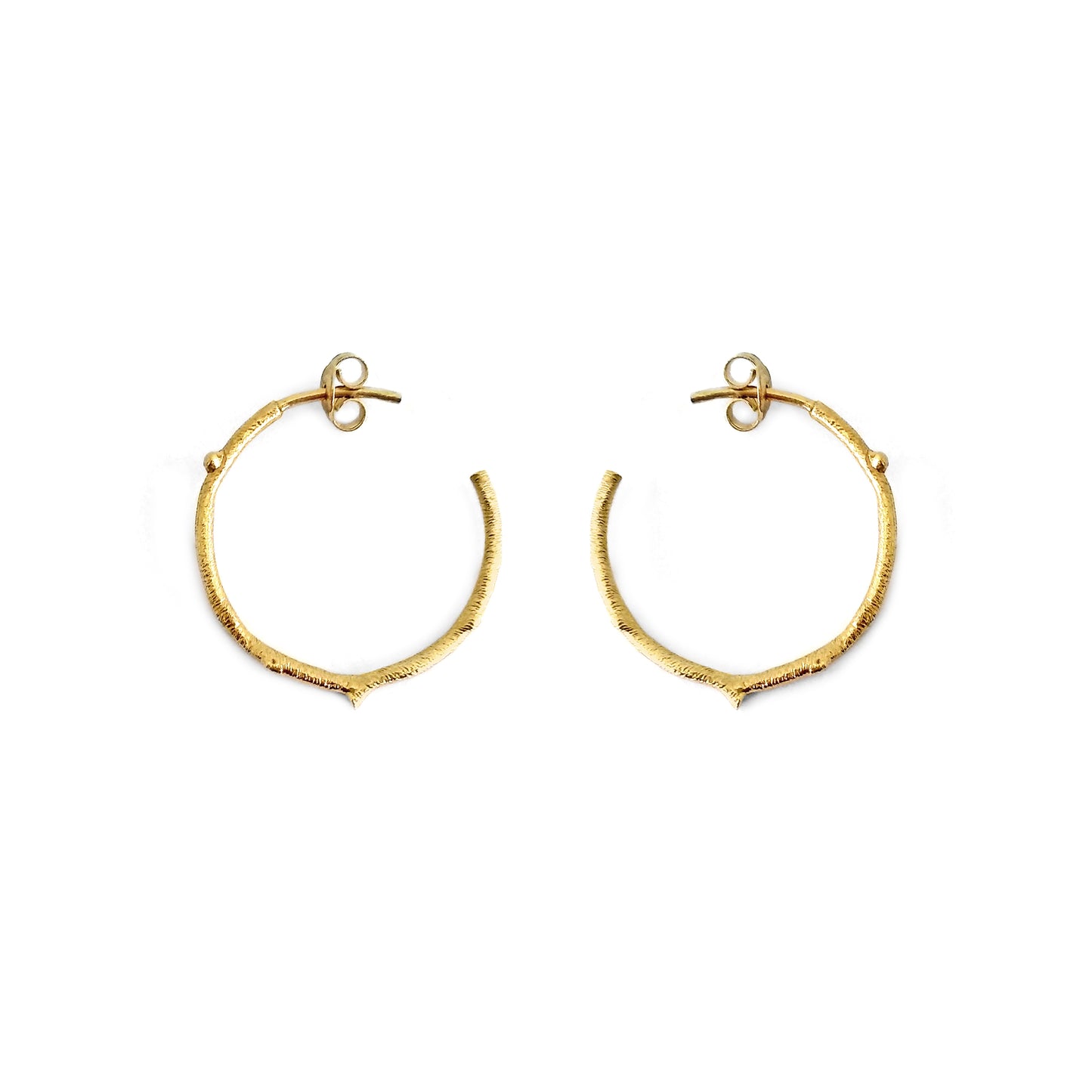 pair of solid yellow gold hoop earrings with a twig branch like design