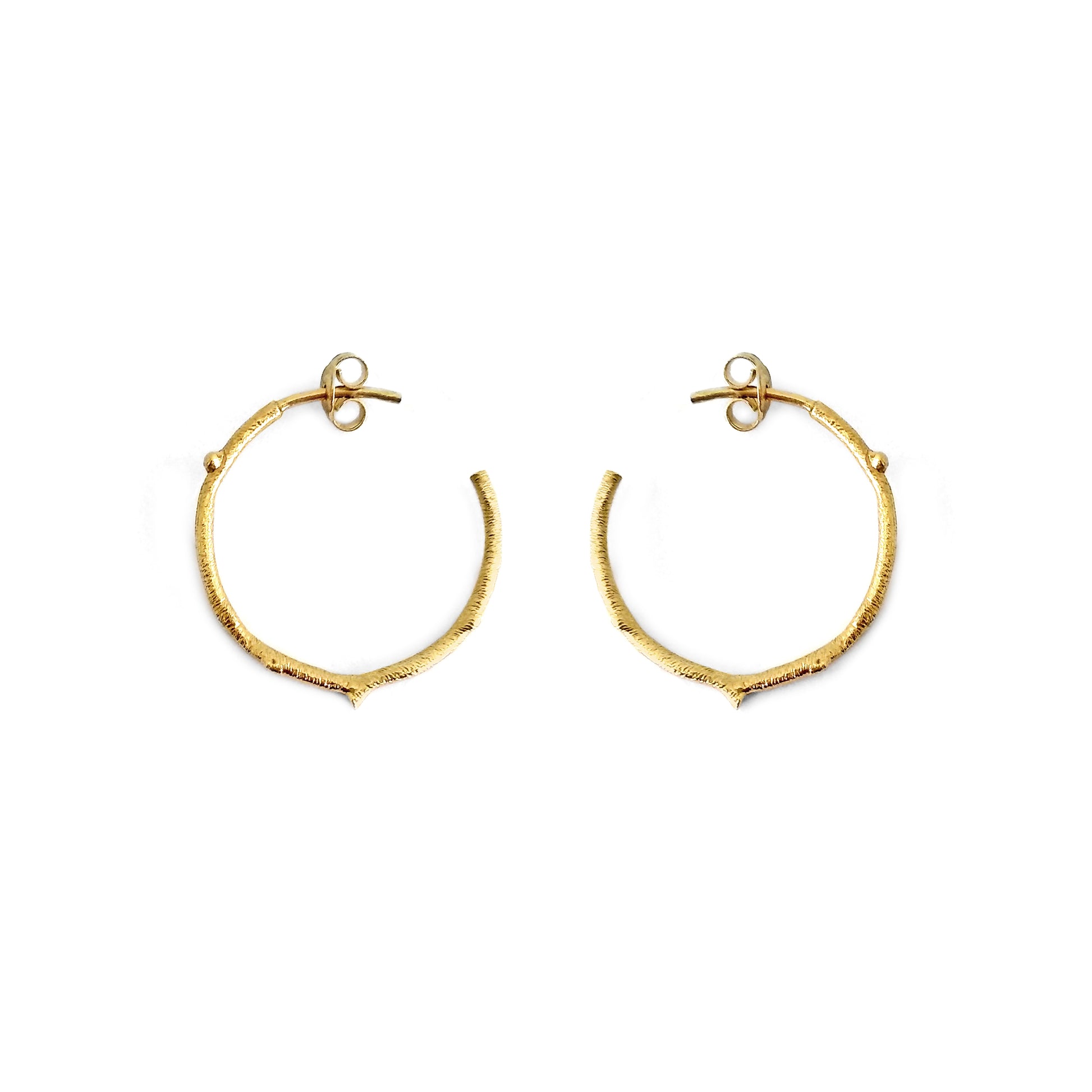 pair of solid yellow gold hoop earrings with a twig branch like design