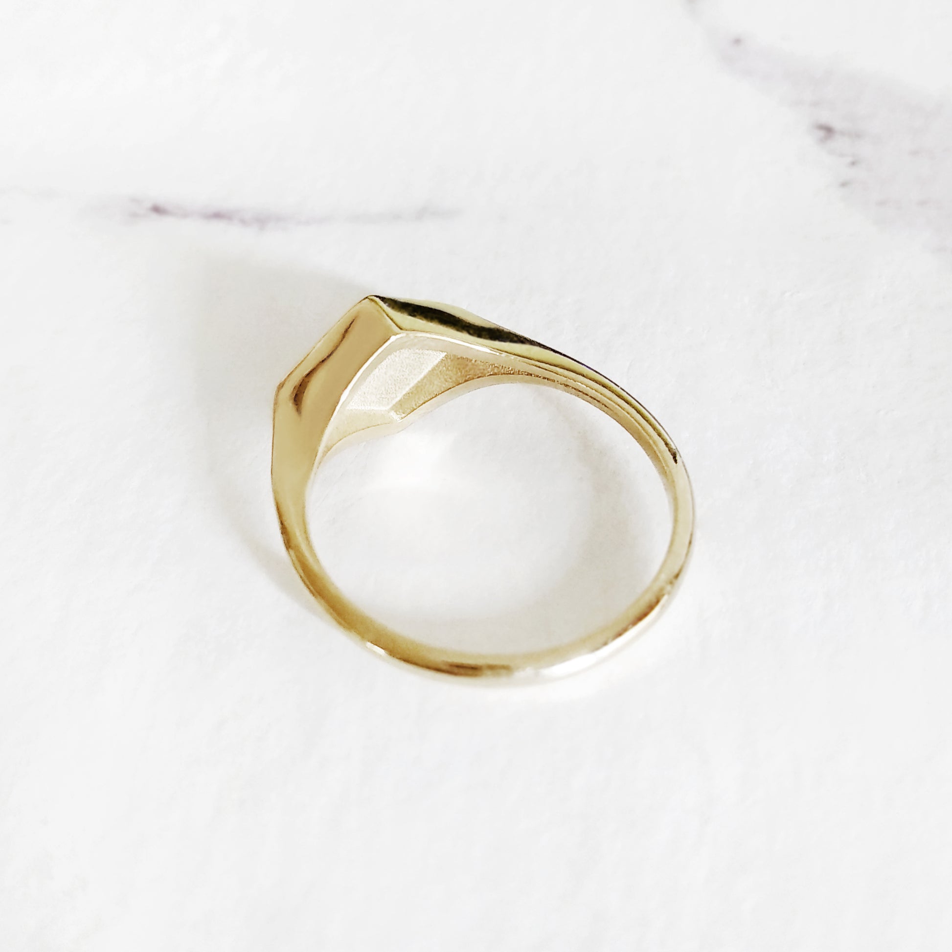 semi hollow back of a gold rhombus signet ring