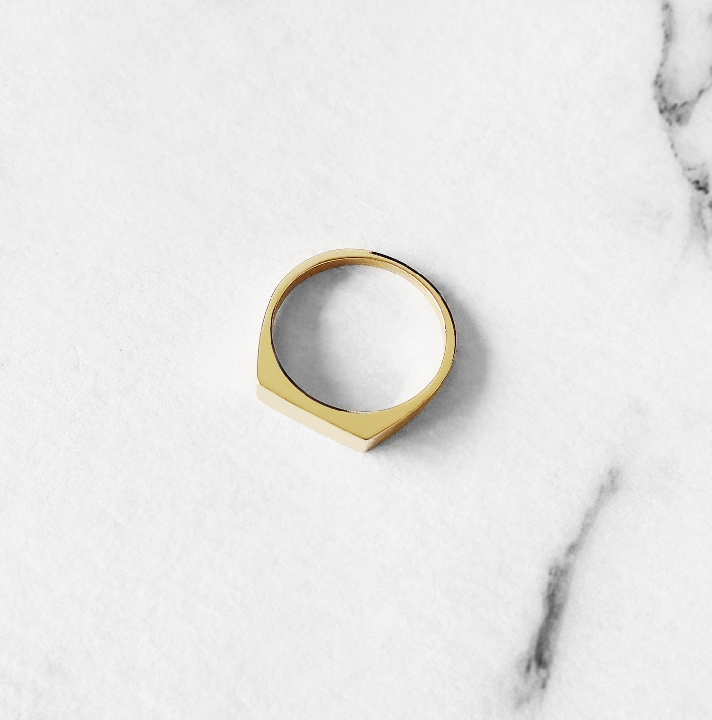 top view of solid yellow gold rectangle bar signet ring