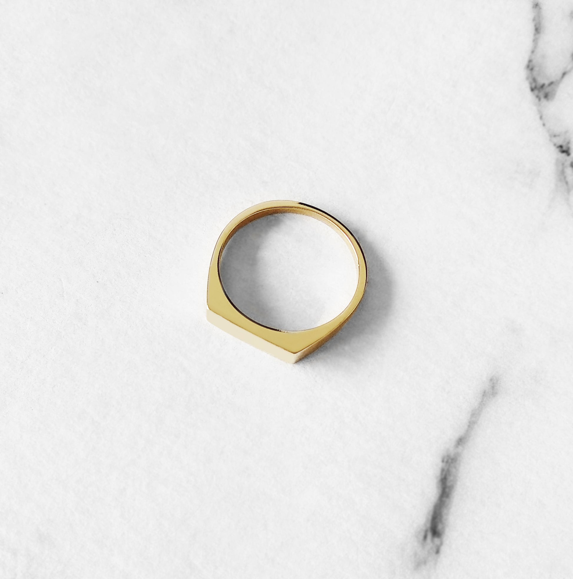 top view of solid yellow gold rectangle bar signet ring