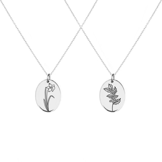 two solid yellow gold oval pendant necklaces engraved with the birth flowers of December Holly and Narcissus