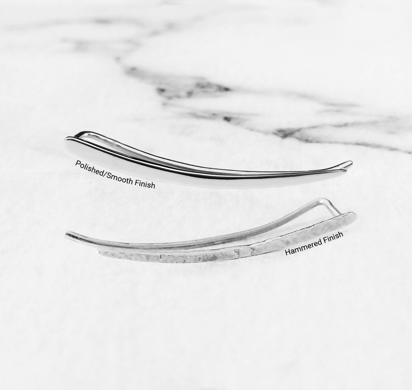 close up of two solid white gold climber earrings one with a polished smooth finish and the other with a polished finish