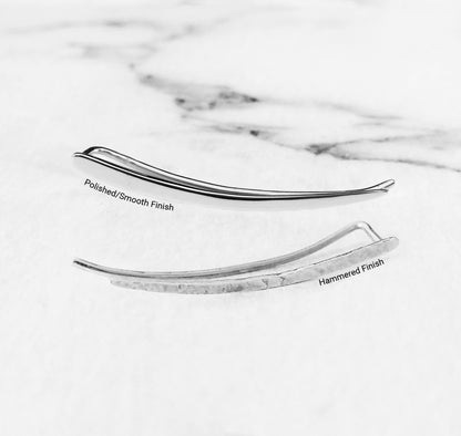 close up of two solid white gold climber earrings one with a polished smooth finish and the other with a polished finish