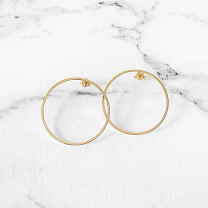 a pair of big open circle hoop stud earrings in yellow gold