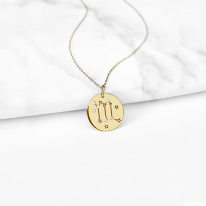 gold necklace with a 14mm disc pendant engraved with the scorpio zodiac sign and set with six tiny diamonds