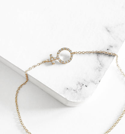 14K yellow gold bracelet with a venus female symbol charm set with tiny diamonds