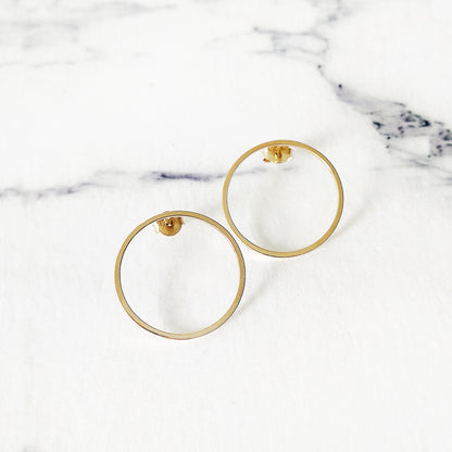 a pair of open circle hoop stud earrings in yellow gold