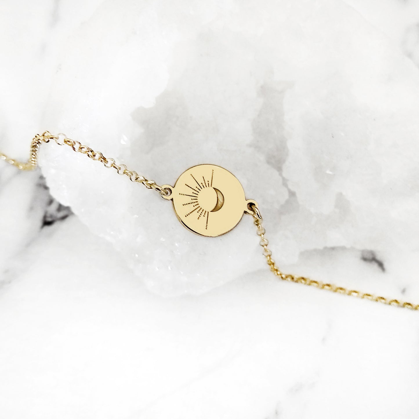 14K yellow gold disc charm bracelet engraved with a crescent moon and sun rays