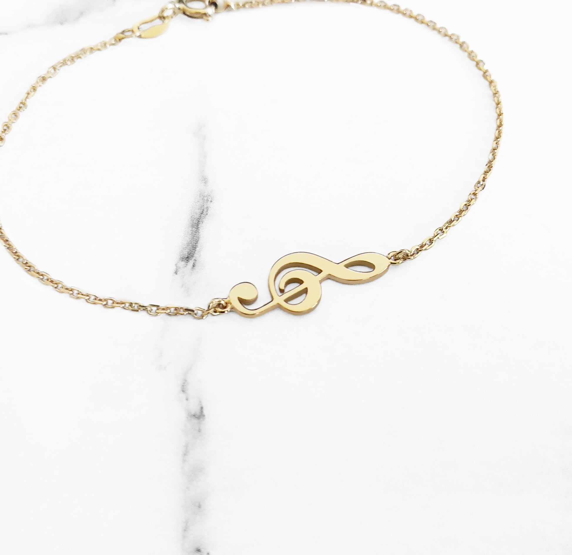 14K yellow gold treble clef music charm bracelet